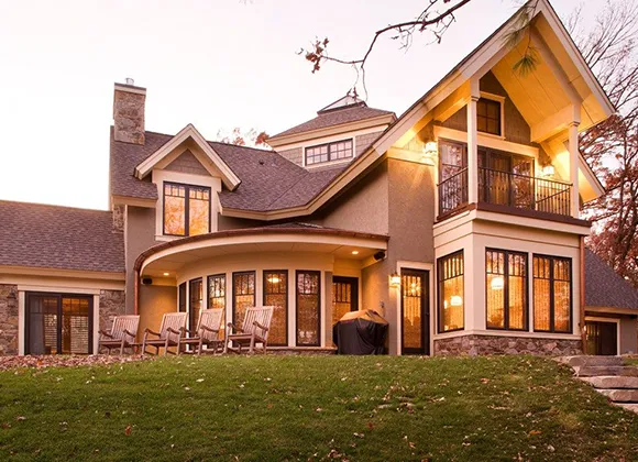 Beautiful classic suburban home with warm lighting, emphasizing quick home-selling solutions.